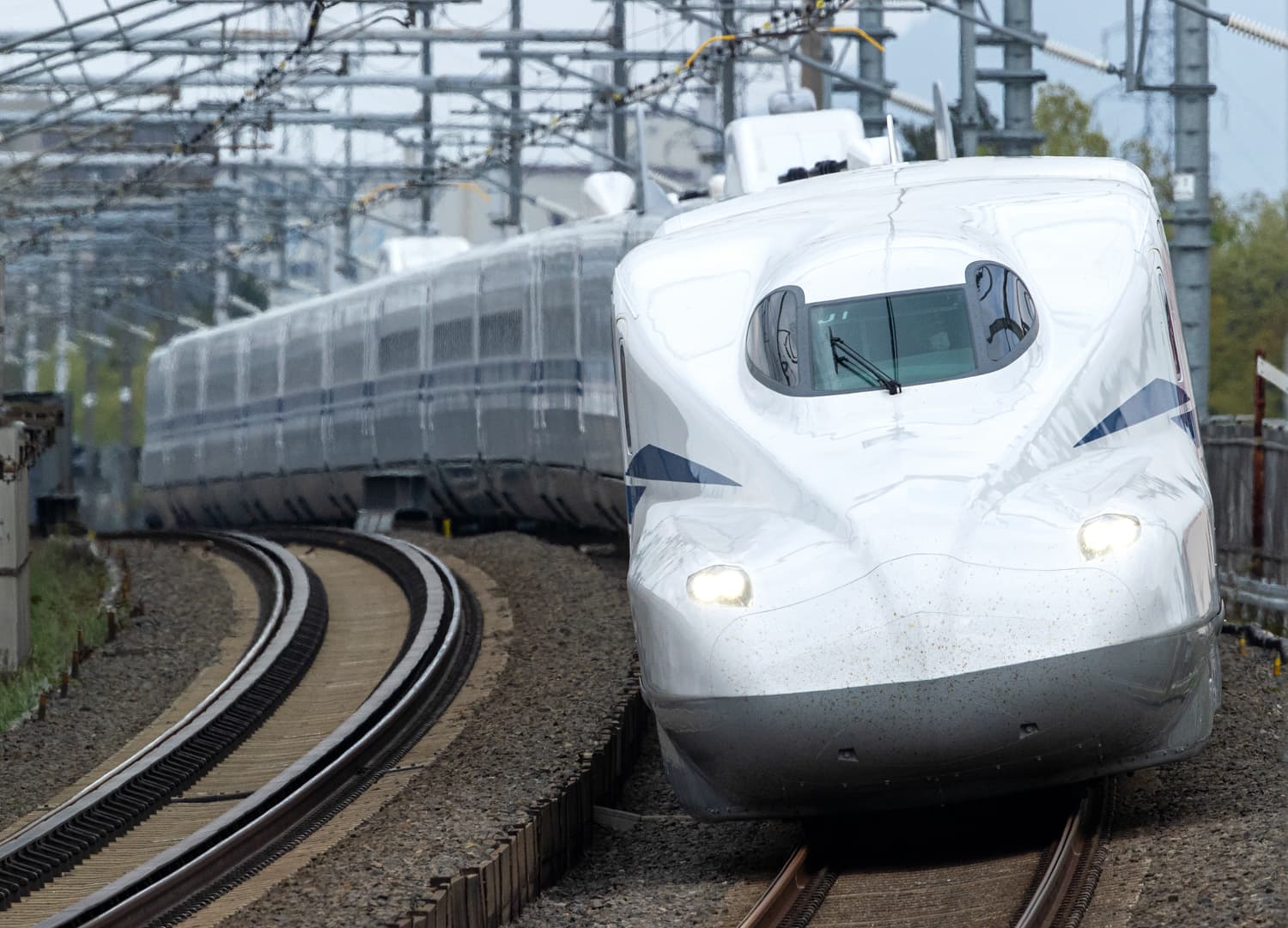 Shinkansen on ballasted track with overhead catenary — dedicated high-speed rail infrastructure